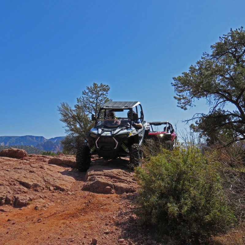a truck driving down a dirt road