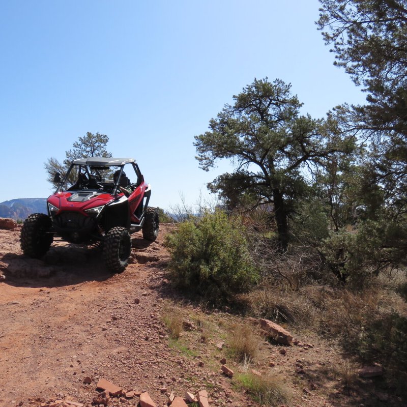 a truck driving down a dirt road