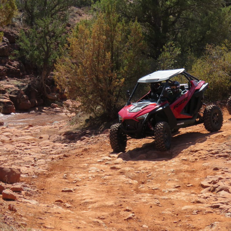 a person riding a motorcycle down a dirt road