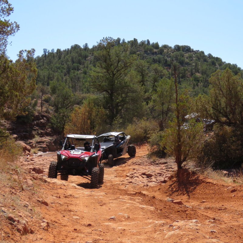 a truck driving down a dirt road