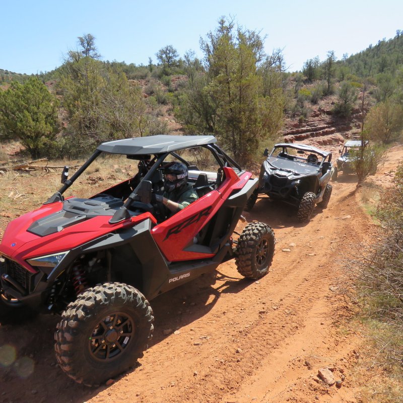 a motorcycle parked on the side of a dirt road