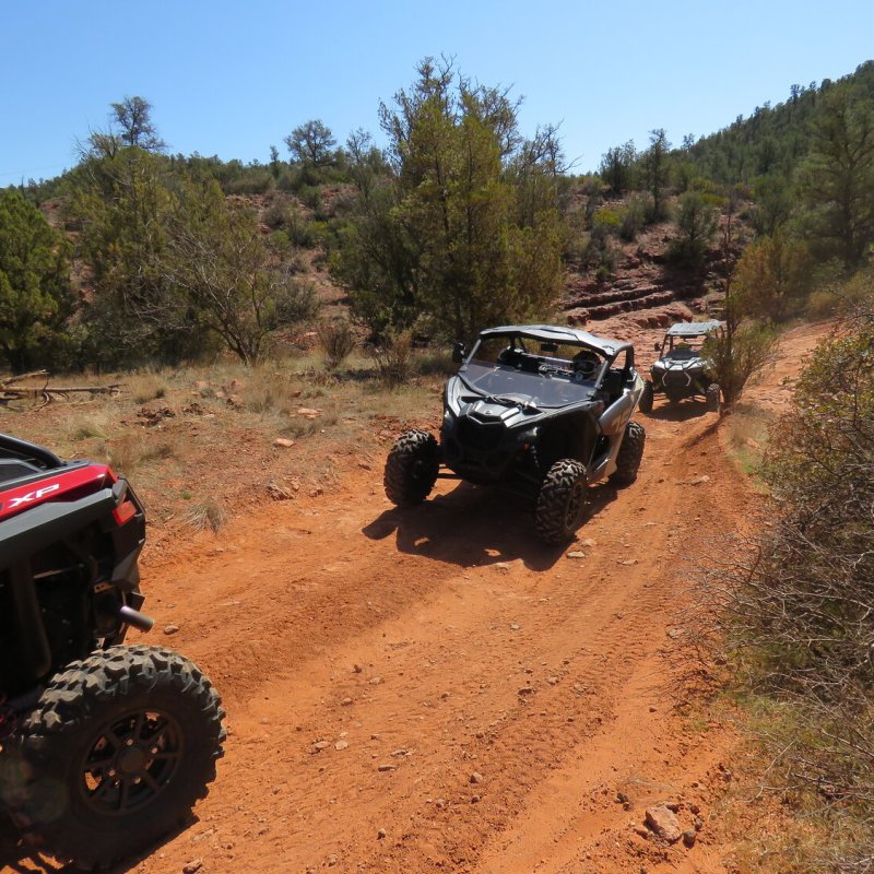 a car parked on the side of a dirt road