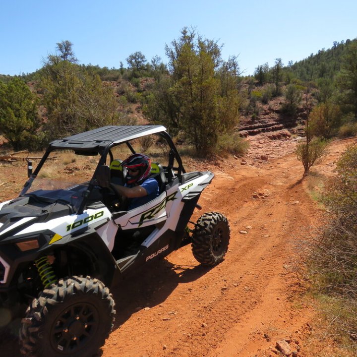 a motorcycle is parked on the side of a dirt road