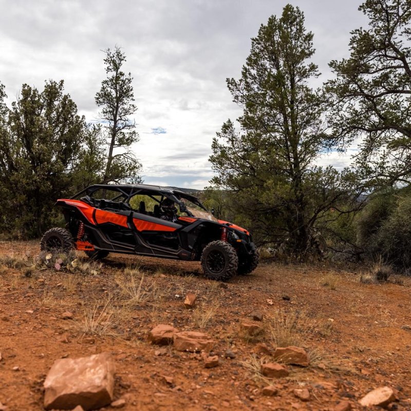 a truck is parked on the side of a dirt field