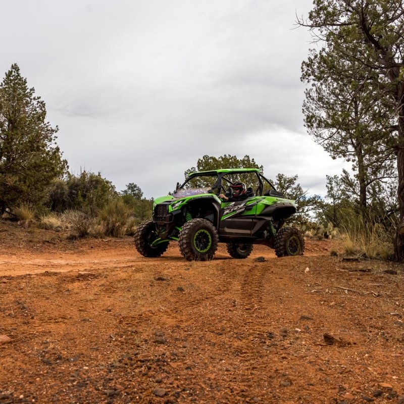 a truck driving down a dirt road