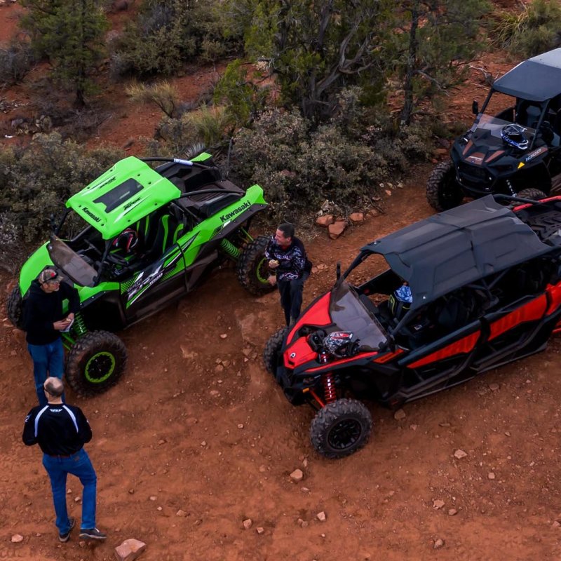 a person riding a motorcycle down a dirt road