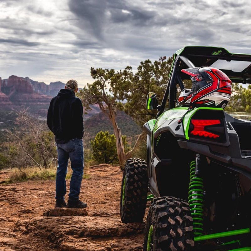 a person flying a kite on a dirt road