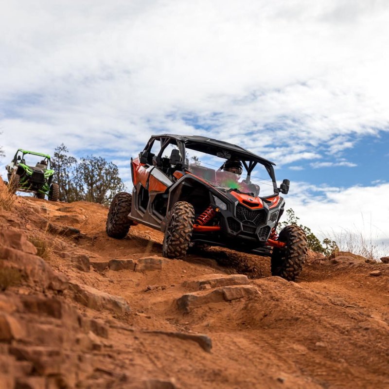 a truck driving down a dirt road
