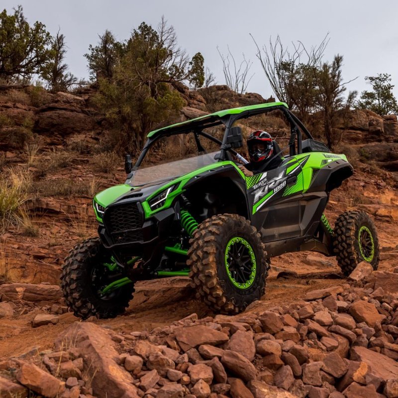 a person riding a motorcycle down a dirt road