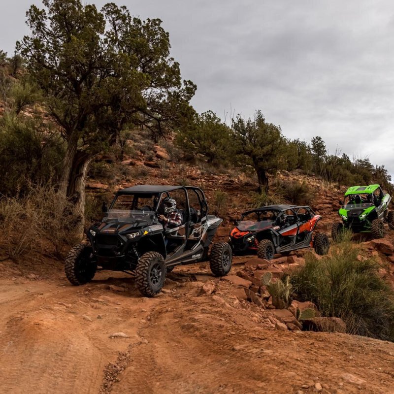a car parked on the side of a dirt road