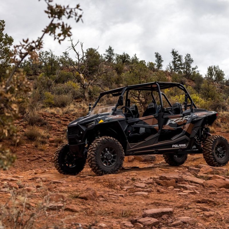 a truck driving down a dirt road