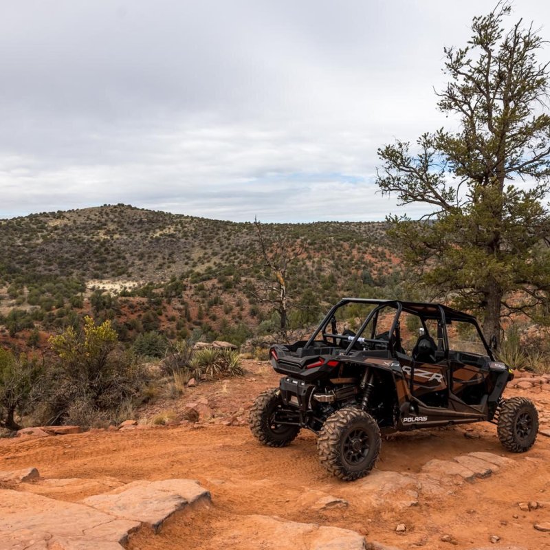 a motorcycle parked on the side of a dirt road