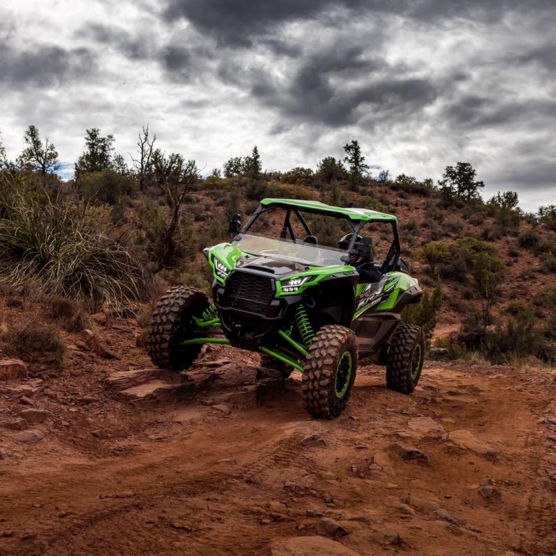 a person riding a motorcycle down a dirt road